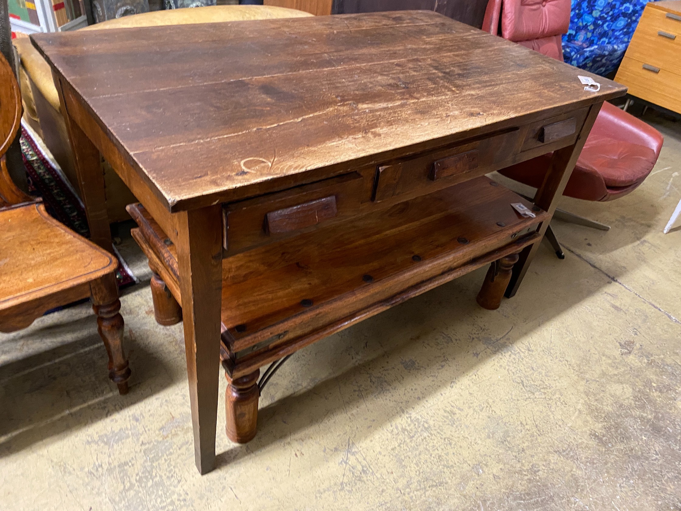 A mid century oak writing table with planked top and three drawers, length 130cm, depth 78cm, height 78cm